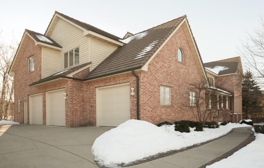 Large brick home with three stall attached garage